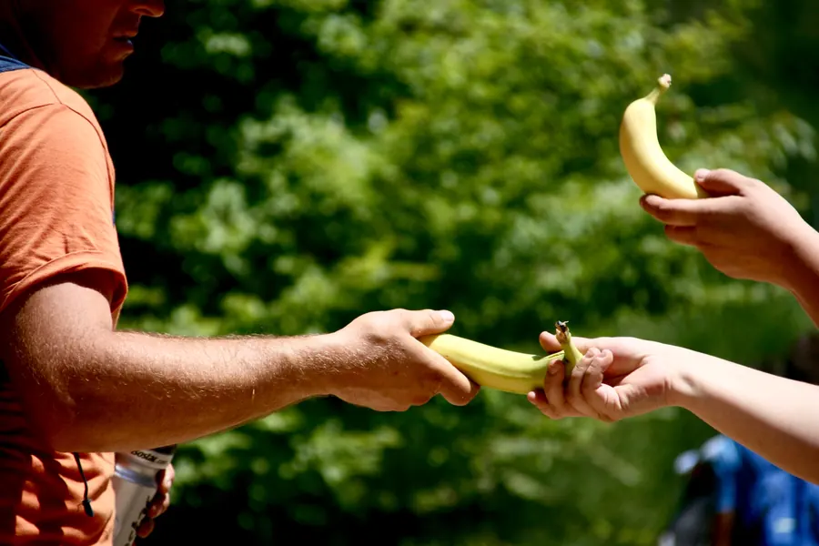 A banana handed to a marcher by a volunteer