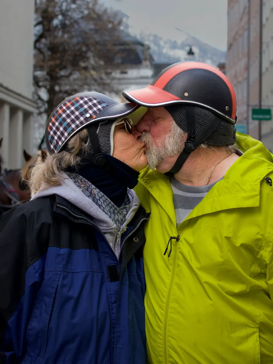 Couple in cycling helmets kissing